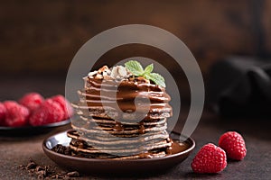 Stack of chocolate pancakes with sauce