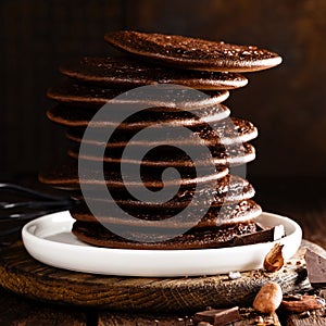 Stack of chocolate pancakes on wooden table
