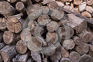Stack of chopped woodfire closeup. Trunk concept. Cracked logs texture. Old cut firewood.