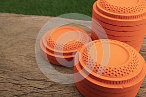 Stack of Clay disc flying targets on wooden table background ,Clay Pigeon target game
