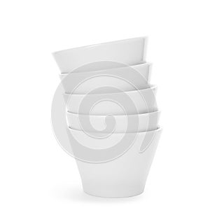 Stack of clean bowls on white background