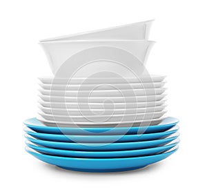 Stack of clean plates and bowls on white background