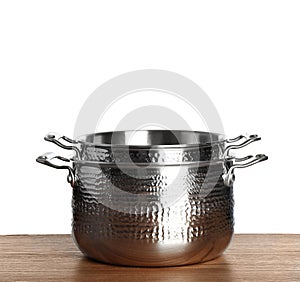 Stack of clean saucepans on table photo