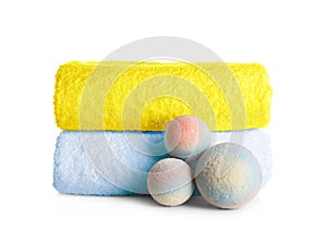 Stack of clean soft towels and bath bombs
