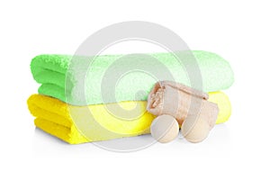 Stack of clean soft towels, bath bombs and sponge