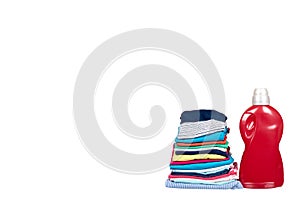 Stack of clothes and detergent bottle, fresh laundry textile