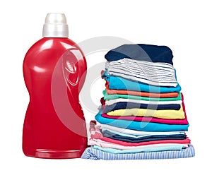 Stack of clothes and detergent bottle, fresh laundry textile