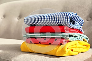 Stack of clothes on sofa