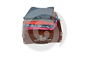 Stack of clothes on suitcase isolated on white background