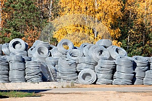 Stack of coiled plastic pvc Polyethylene Corrugated drainage pipes for sewer system outdoor warehouse