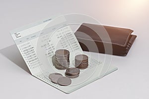 Stack of coins and account book bank on the table