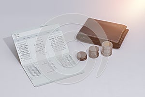 Stack of coins and account book bank on the table