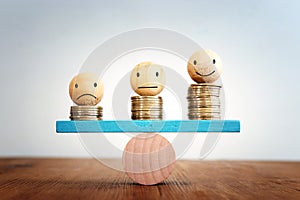 Stack of coins balance on seesaw