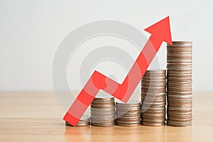 Stack of coins bar chart and red graph growing up with white wall background copy space. Business financial, successful investment