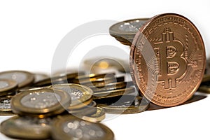 Stack of coins and a bitcoin. Crypto currency investment concept