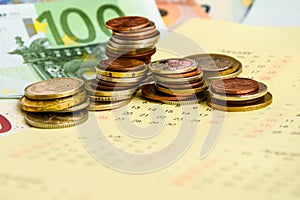 Stack of coins on calendar, closeup shot, for finance background