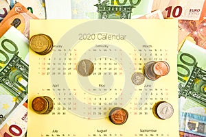 Stack of coins on calendar, closeup shot, for finance background