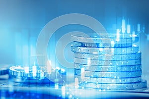 Stack of coins and financial equity market chart