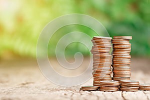 Stack of coins growing with sunray for saving money