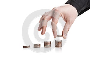 Stack of coins and human hand