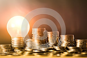 Stack of coins and light bulb for saving money concept, Creative ideas of business planning, success in the future