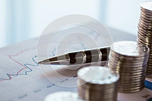 Stack of coins with line chart