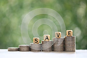 Stack of coins money on natural green background, Save money for prepare in future and pension retirement concept