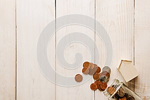 Stack of coins on old white wooden floor. ideas about saving money for house