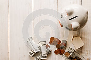 Stack of coins on old white wooden floor. ideas about saving money for house