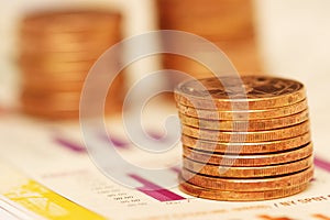 Stack of coins over bar charts