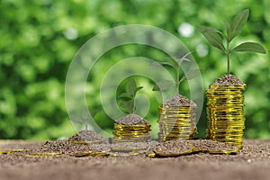 Stack of coins with piggy bank against green bokeh background