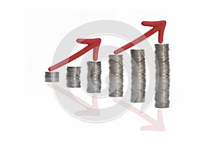 Stack of coins and red arrow with reflection on white background