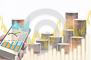 Stack of coins on technology and financial growth graph on white background