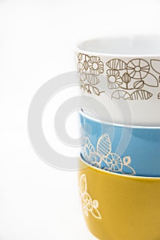 Stack or collection of ceramic bowls, floral ornament, pastel colors, styled image for social media