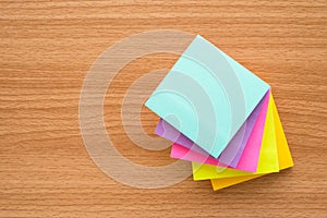 Stack of color paper notes on wood table with copy space