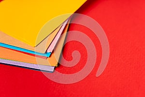 A stack of colored envelopes on a red background