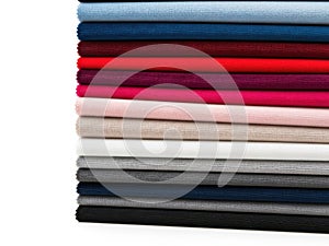 Stack of colored fabrics isolated on white background