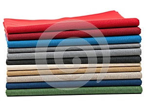 Stack of colored fabrics isolated on white background