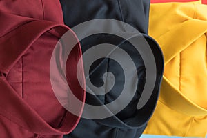 Stack of colored men shirt red,black and yellow