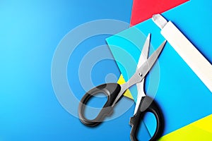 Stack of colored paper with scissors and cutter