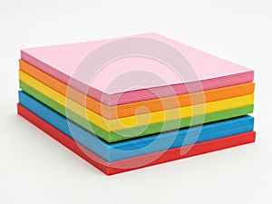 Stack of colored paper sheets isolated on white background