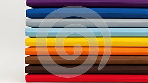 Stack of colored paper sheets isolated on white background