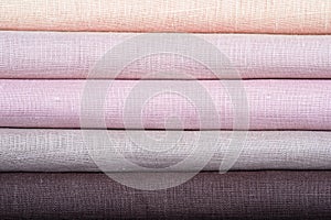 A stack of colored pastel linen fabric, close-up