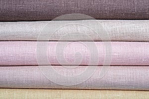 A stack of colored pastel linen fabric, closeup