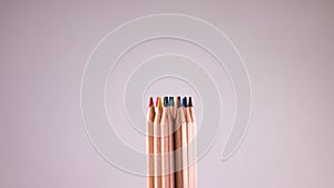 Stack of colored pencils on light grey background
