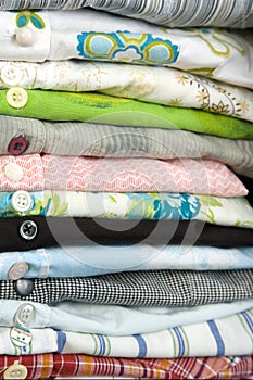 Stack of colored shirt, details of buttons