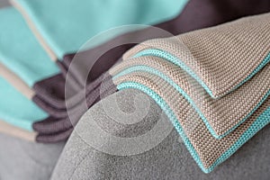 The stack of colored striped coverlets is on a gray background