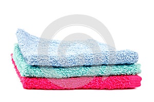 Stack of colored towels isolated on a white background