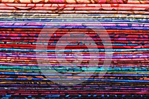 Stack of colorful batik fabrics as a vibrant background