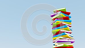 Stack of colorful books against blue sky,